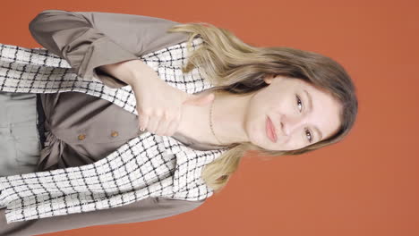 Vertical-video-of-Young-woman-making-positive-gesture-at-camera.